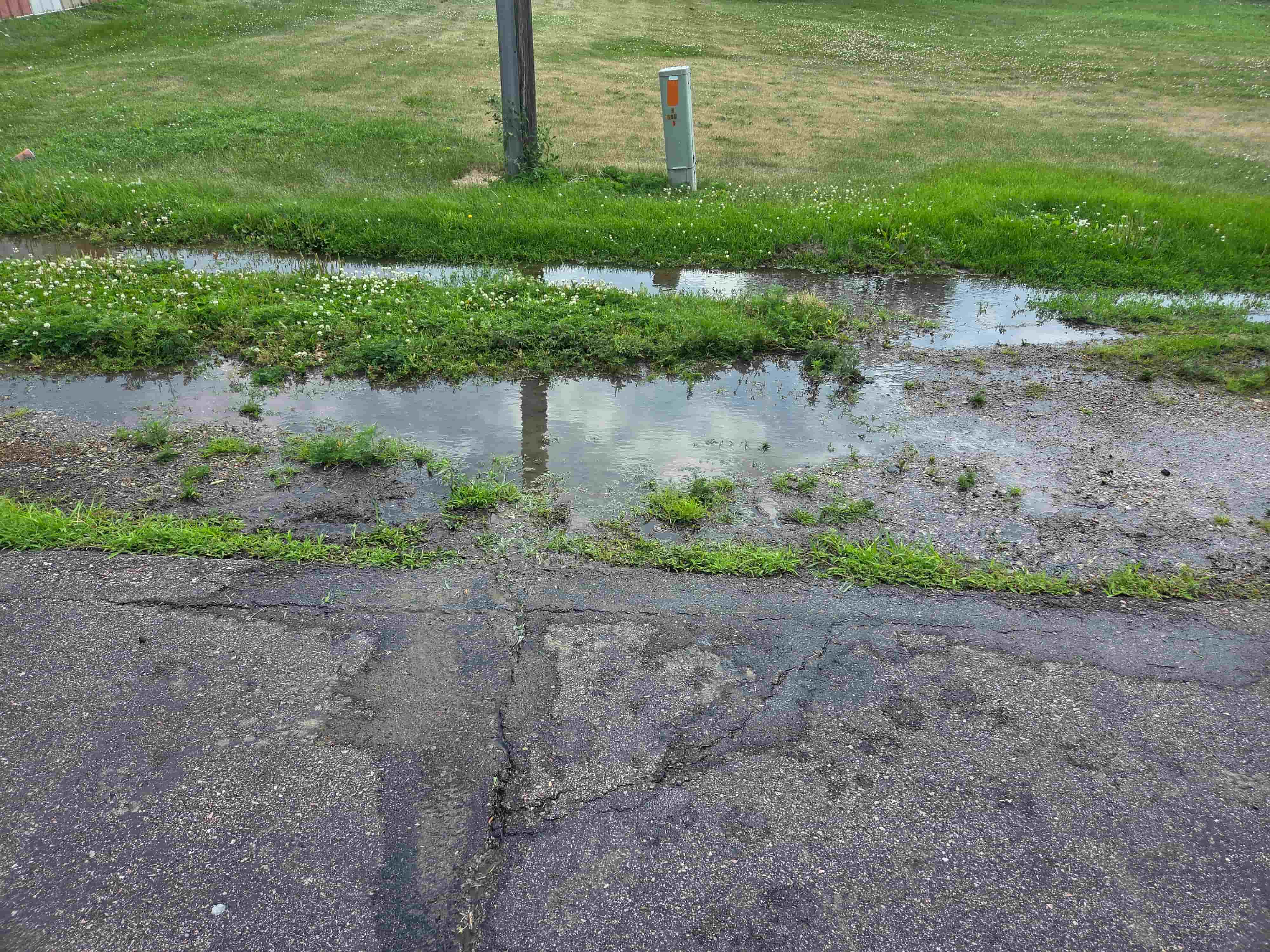Excavator opening a utility trench